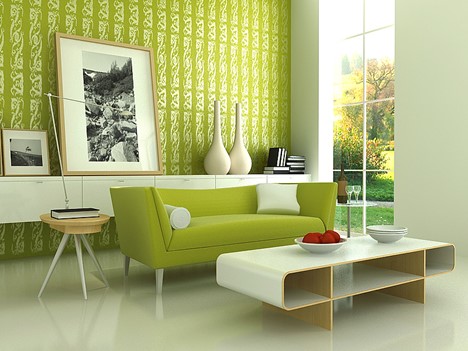 Green couch and walls in a bright living room with lots of windows, optimizing relationships of functional spaces.