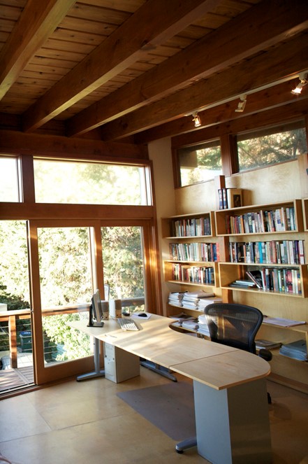 stainable wood desk in a office with wooden shelves filled with books