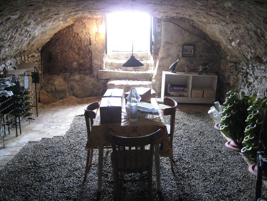 Wooden table in the middle of a wine cellar