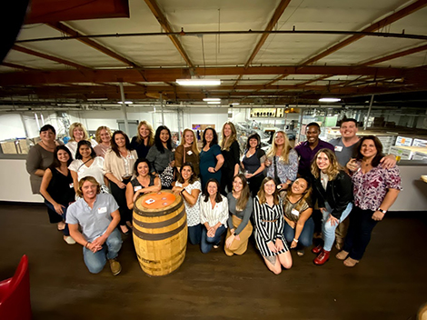 DI graduates gathered for for a photo at local distillery Cutwater Spirits