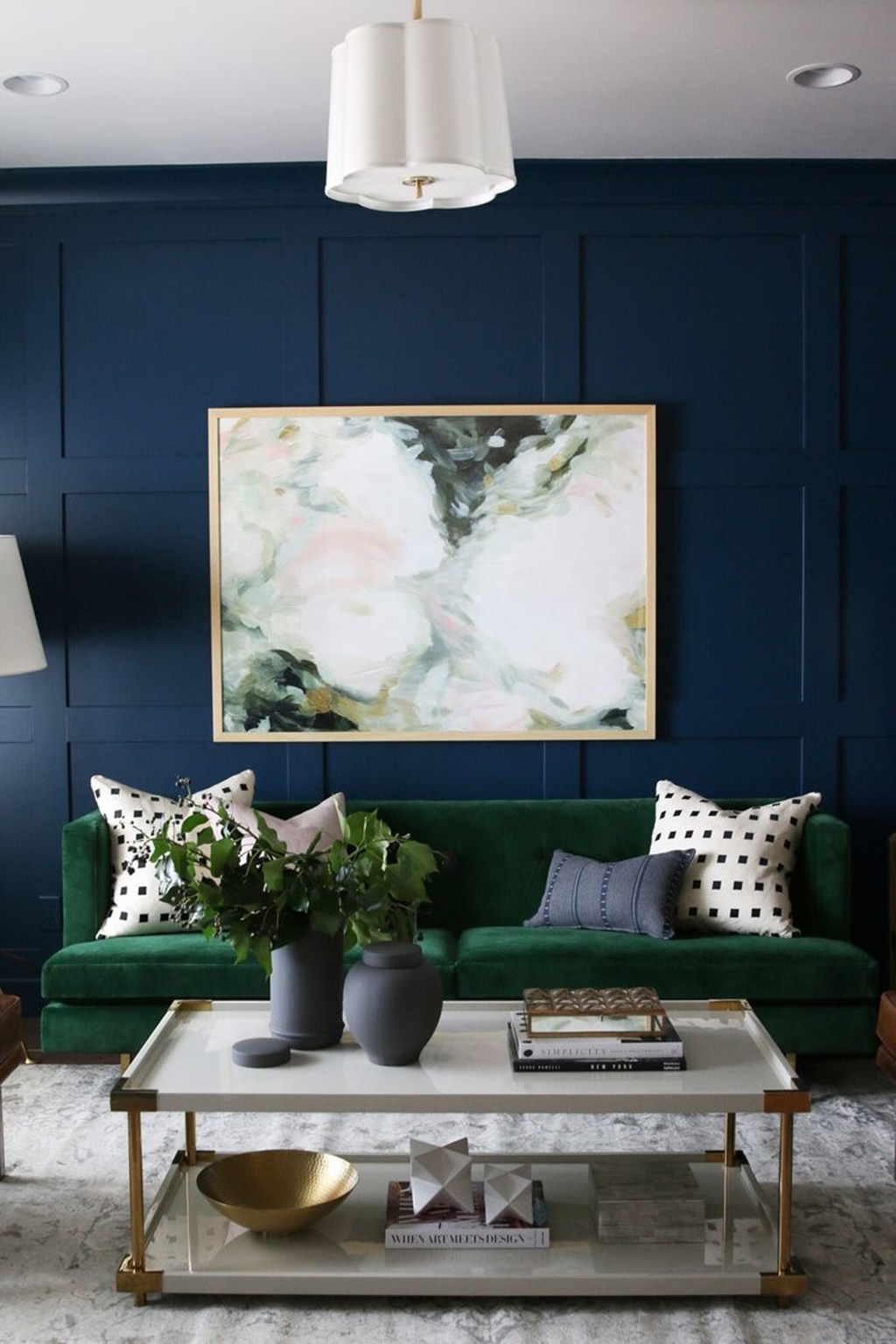 Go bold, or go home. Love this forest green velvet sofa against that regal royal blue wall. 