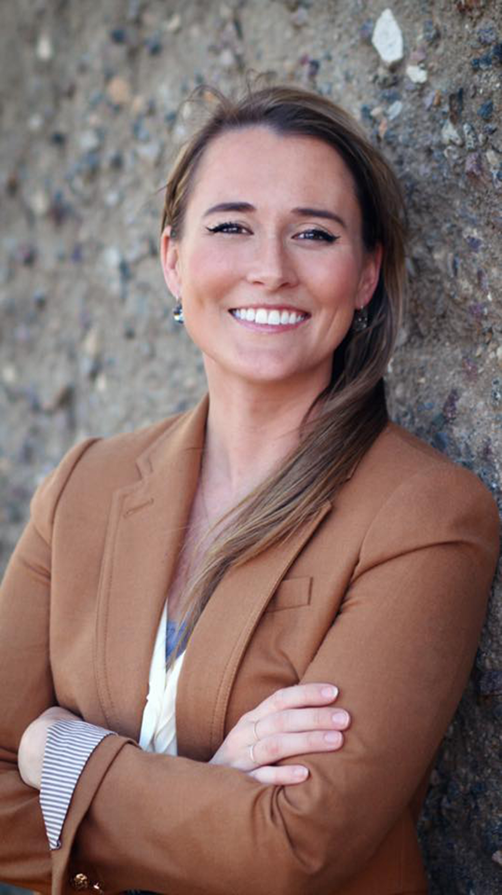 Chelsea Metheny - A smiling female student with arms crossed