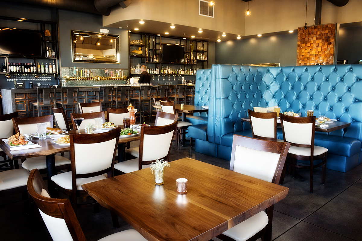 A view of the dining area with the bar located in the background. Located inside Public House 131