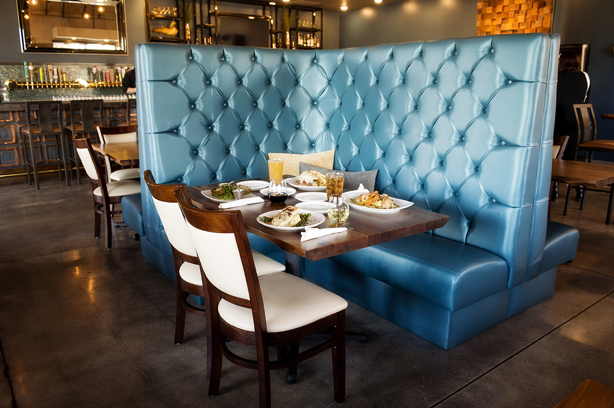 A close-up shot of one of the high-back booths in the dining area. Food served on the table