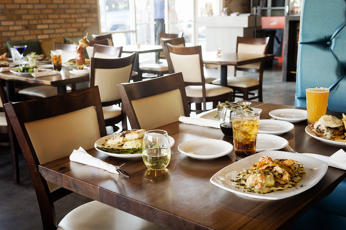 A close-up view of a dining table to seat 4, with Public House 131's food served on the tables